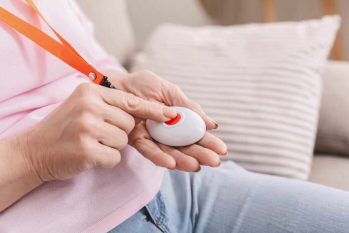 Senior woman hand pressing Alarm Button, closeup