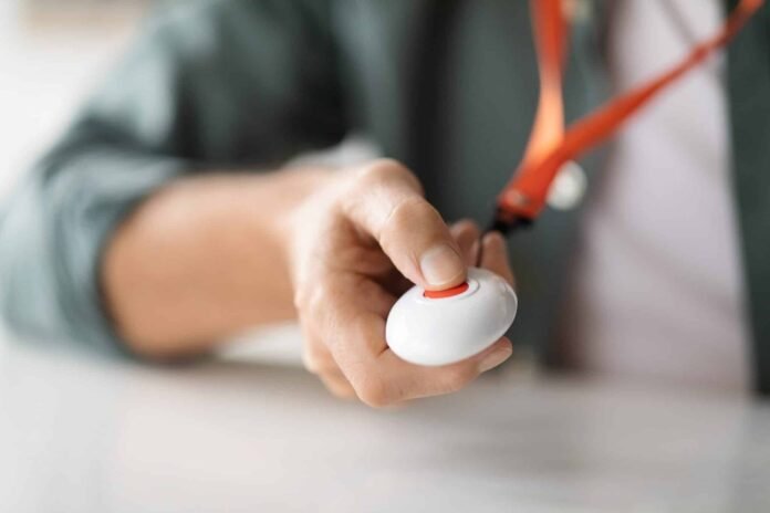 Unrecognizable senior man pushing panic button on emergency equipment