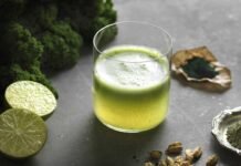 The Power Of Greens And Superfoods: How To Unlock Optimal Health And Well-Being High angle view of green raw juice with halved lime and nutritional supplement