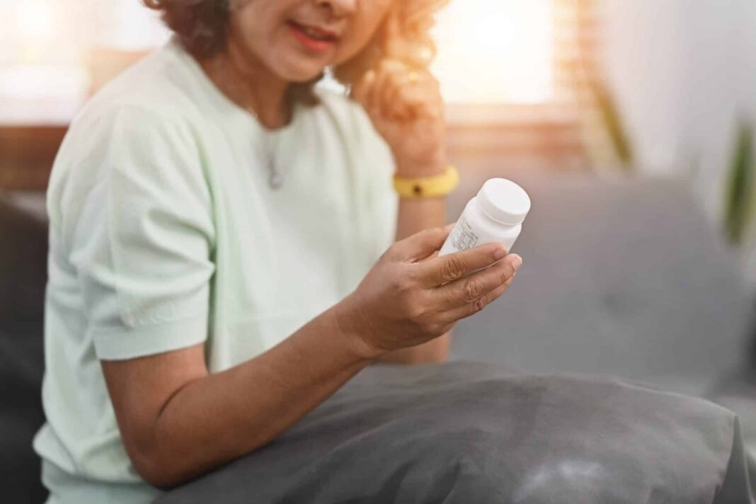 Photo of mature woman woman taking daily medicine. Elderly healt