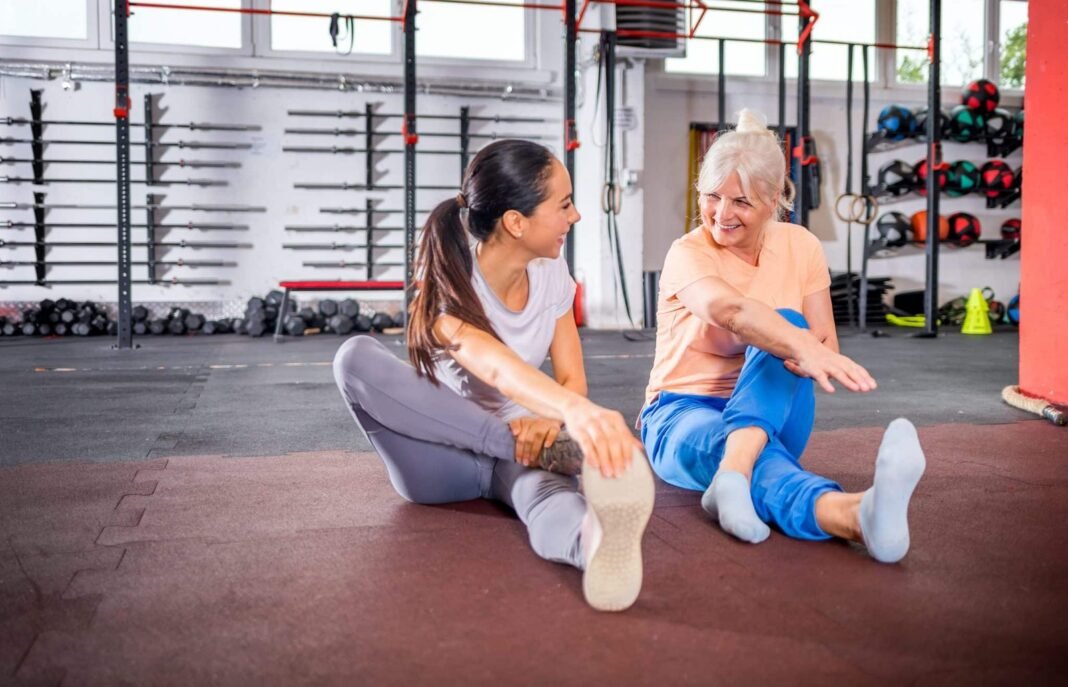 Senior woman workout with trainer at the gym