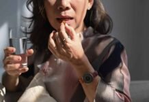 Why Taking A Zinc Supplement Could Be The Best Choice For You Mature woman holding glass of fresh water, taking dietary supple