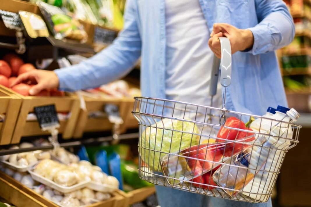 Closeup of man shopping groceries, buying vegetables