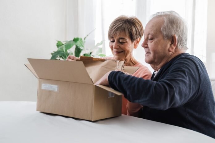 Happy senior couple unpacking parcel box from onli 2021 09 02 09 29 37 utc